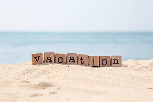 istock Vacation word on sunny beach with ocean background 532131675