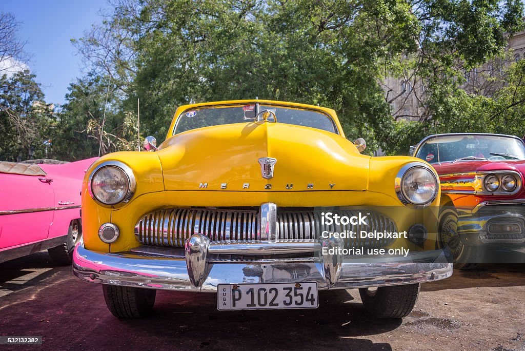 Front of of a yellow classic american Ford Mercury car Havana, Cuba - April 18, 2016: Front of of a yellow classic american Ford Mercury car, in Havana Elegance Stock Photo