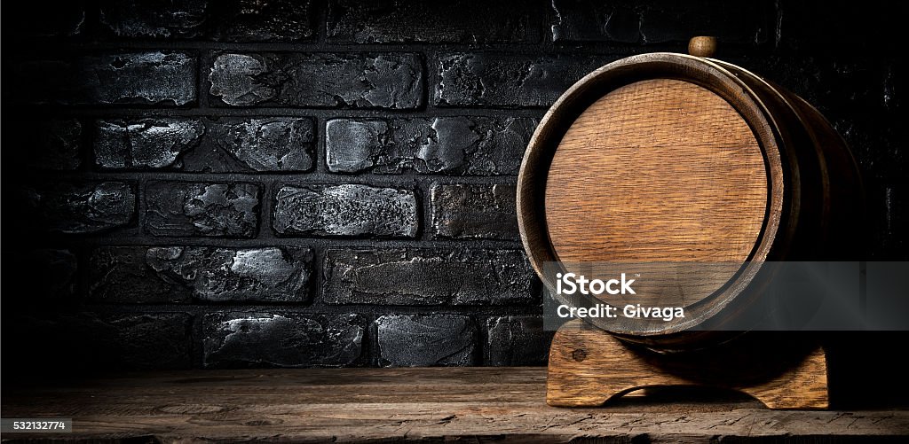 Wooden cask and bricks Wooden cask and wall made of bricks Barrel Stock Photo
