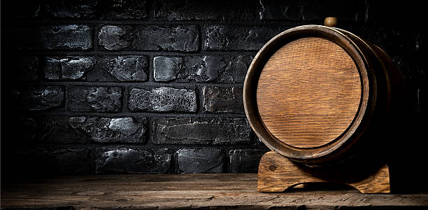 Wooden cask and bricks Wooden cask and wall made of bricks whisky cellar stock pictures, royalty-free photos & images