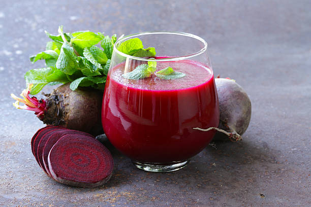 fresh beet juice with mint leaf in a glass fresh beet juice with mint leaf in a glass common beet photos stock pictures, royalty-free photos & images