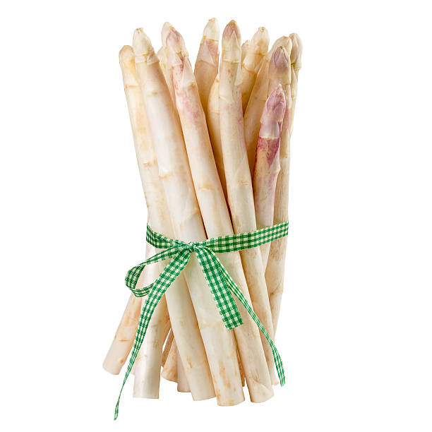 istock Asparagus with green ribbon isolated on white background. 532134044