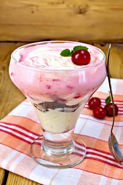 istock Dessert milk with cherry on napkin and board 532134197