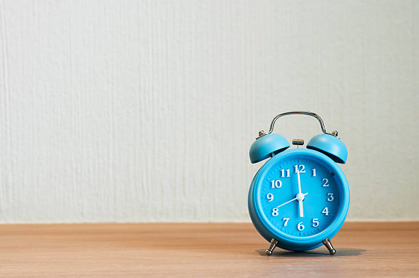 istock Close up of alarm clock on wooden table. 532134426