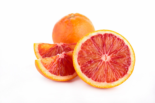 Abundance of blood orange slices on white background