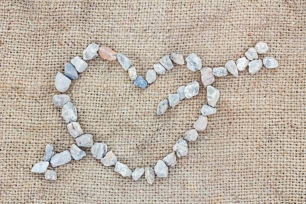 Pebble art of foot print on black frame and background