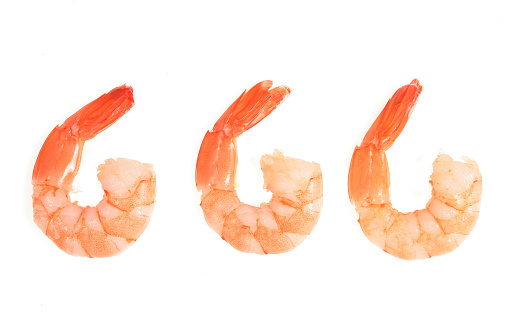 Three cooked fantail prawns isolated on white