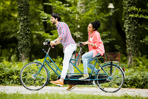 Young couple riding on the bicycle