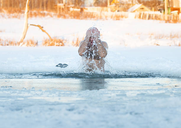 istock Winter swimming. Man to an ice-hole 532147957