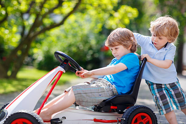istock Two happy sibling boys having fun with toy car 532147969