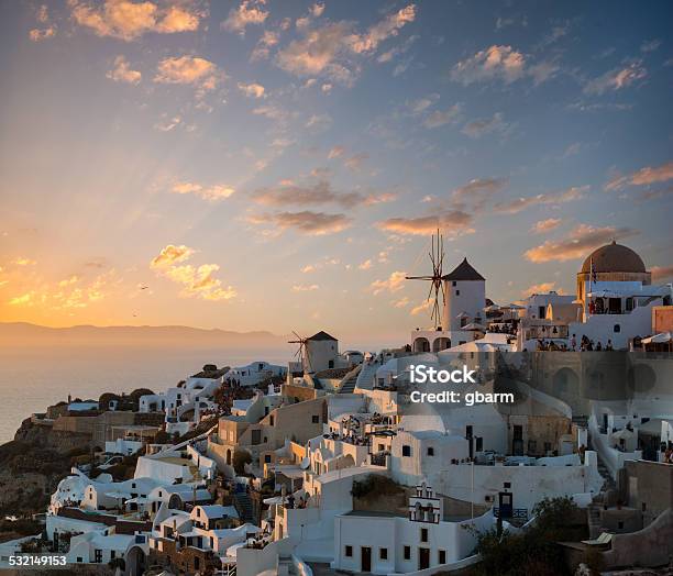 Dramatic Sunset Over The Windmills Of Oia Village Santorini Stock Photo - Download Image Now