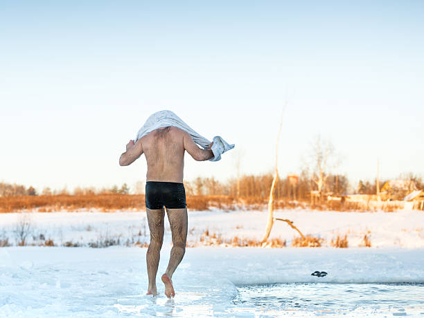 istock man wipes towel after swimming in  freezing hole 532149665