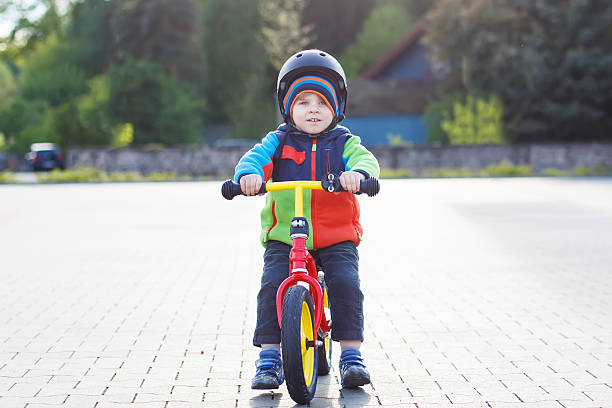 istock Little toddler boy learning to ride on his first bike 532149699