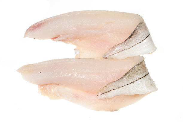 Two haddock fillets Two haddock fillets on a white background haddock stock pictures, royalty-free photos & images