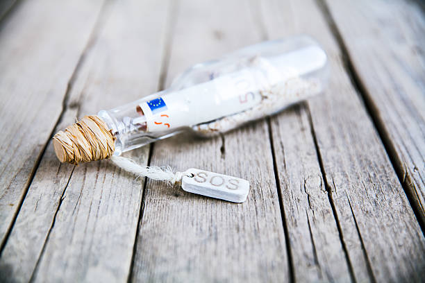 istock message in a bottle on wooden background 532154197