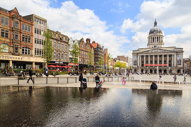 Nottingham Market Square and Council House Nottingham, England - May 17, 2016: Various people sitting, walking, visiting in the main Market Square, Nottingham Council House building behind. market square stock pictures, royalty-free photos & images