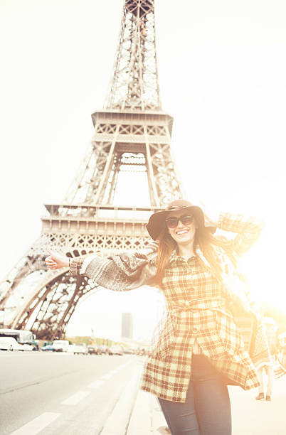 istock Smiling woman with thumb up for hitch-hiking at Eiffel tower 532163574