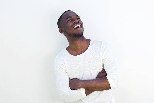 istock Cheerful young black guy standing with his arms crossed 532167322