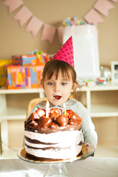 istock Little Girl is Blowing Candles 532167613