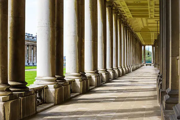 Colonnade and shadow in Old Royal Naval College, University of Greenwich, London.