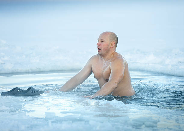 istock Winter swimming. Man in ice-hole 532168477
