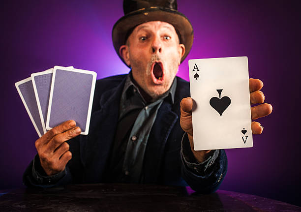 Senior man making trick with playing cards