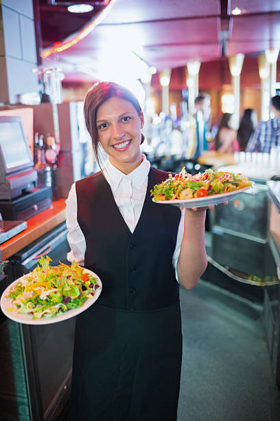 istock Pretty barmaid holding plates of salads 532169805
