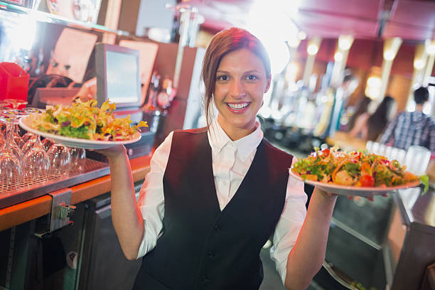 istock Pretty barmaid holding plates of salads 532169809