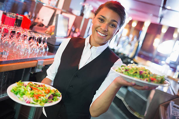 istock Pretty barmaid holding plates of salads 532169953