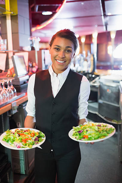 istock Pretty barmaid holding plates of salads 532169961