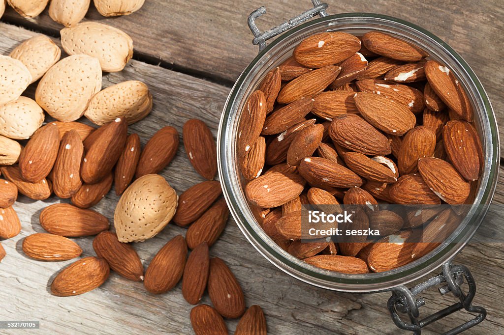 Almonds. Almonds and almonds in shells on a wooden background. 2015 Stock Photo