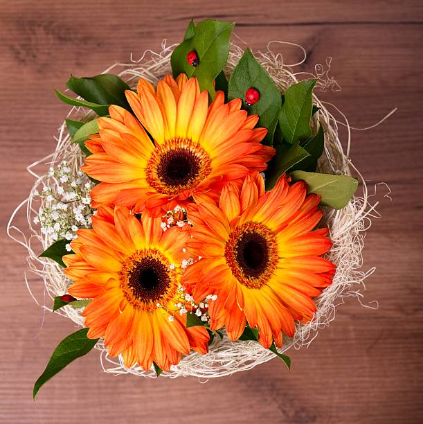 Bunch of flowers in a glass vase, isolated on white