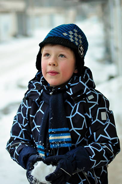 istock boy in winter with snow in hands 532170640