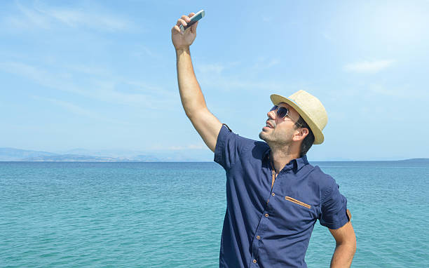 istock Man Taking Selfie With Smart Phone at the Beach 532170804