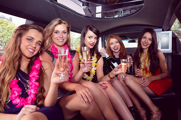 istock Happy friends drinking champagne in limousine 532171603