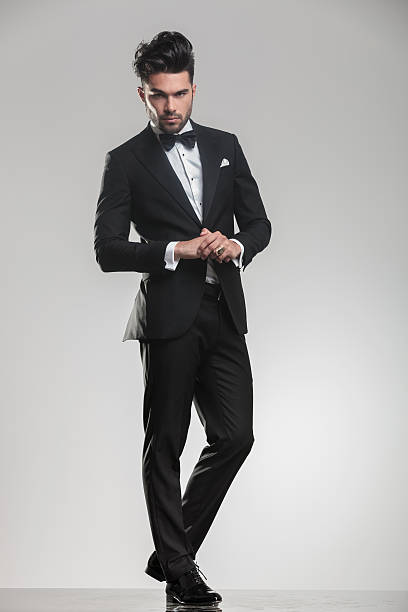 istock elegant young man wearing a tudexo looking at the camera 532172393