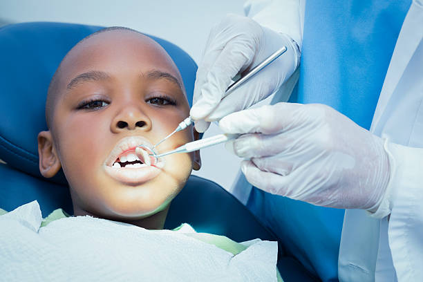 istock Boy having his teeth examined by dentist 532172613