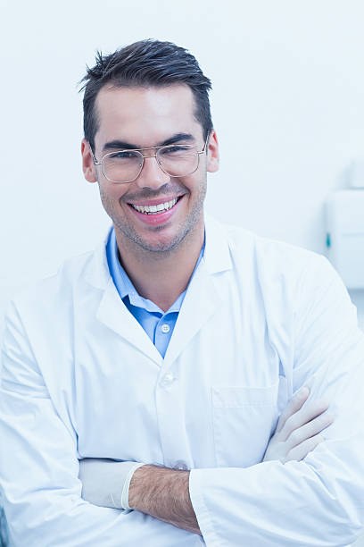 istock Happy male dentist with arms crossed 532172719
