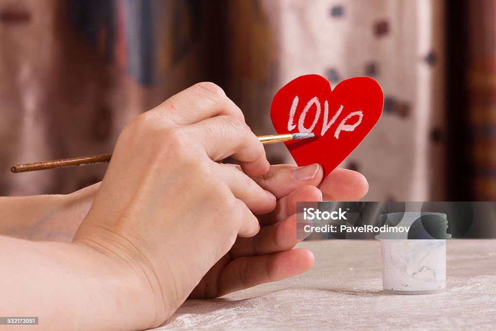 writing on the paper heart for Valentine's day hand writing on the paper heart for Valentine's day 2015 Stock Photo