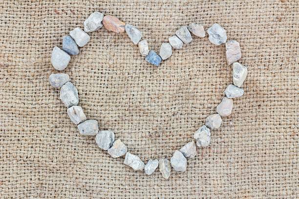 Heart pattern of stones on grassy field