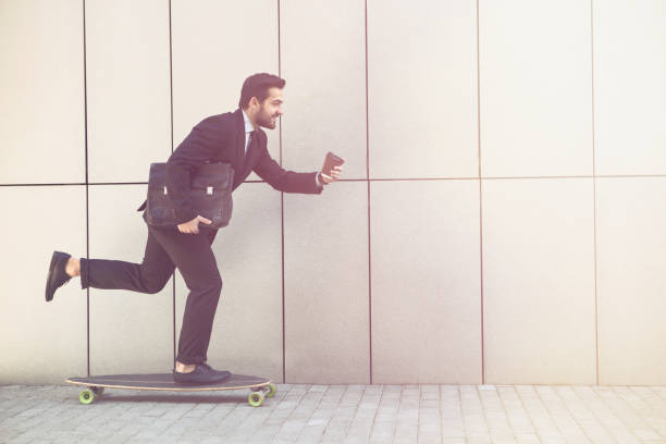 istock Businessman on longboard with cup of coffee 532173294