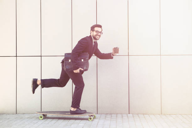 istock Businessman on longboard with cup of coffee 532173570