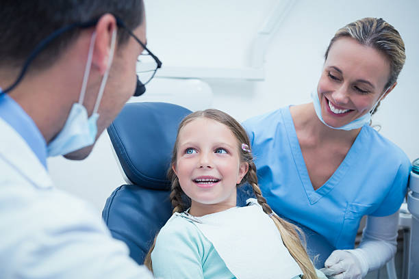 istock Dentist with assistant examining girls teeth 532173883