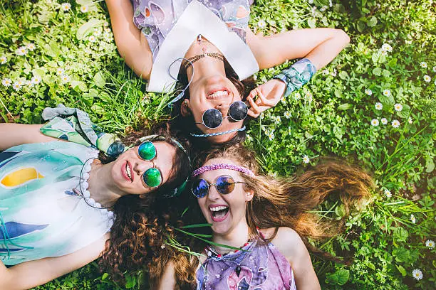 Photo of Smiling faces of hippie female friends