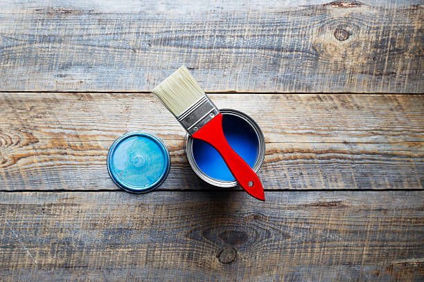istock open jar with blue paint and red brush top view 532177316