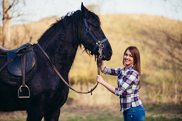 istock young woman with horse in spring sun nature 532178446