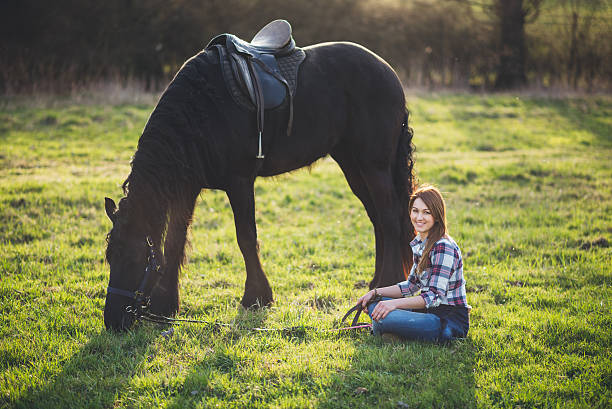 istock young woman with horse in spring sun nature 532179436