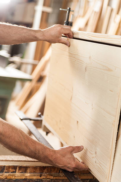 istock woodworker hands with wooden board 532179670