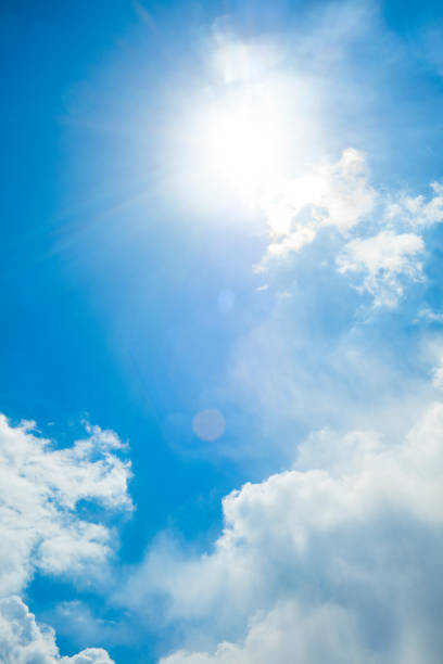 istock View of blue sky with sun and sunrays between clouds 532179740