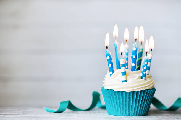 Birthday cupcake Cupcake with blue birthday candles cupcake candle stock pictures, royalty-free photos & images